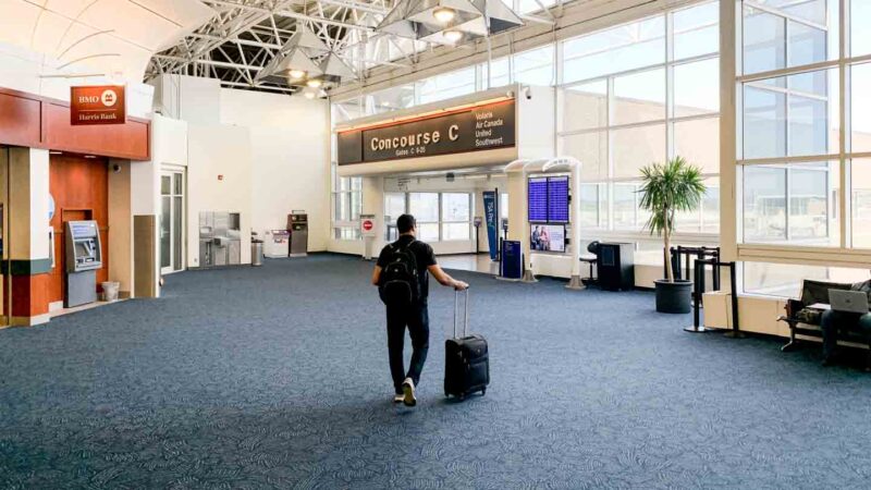 man walking toward Concourse C iin the Milwaukee Airport after Parking