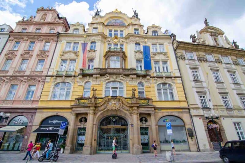 Yellow building with flags near Paris street in Prague Jewish Quarter