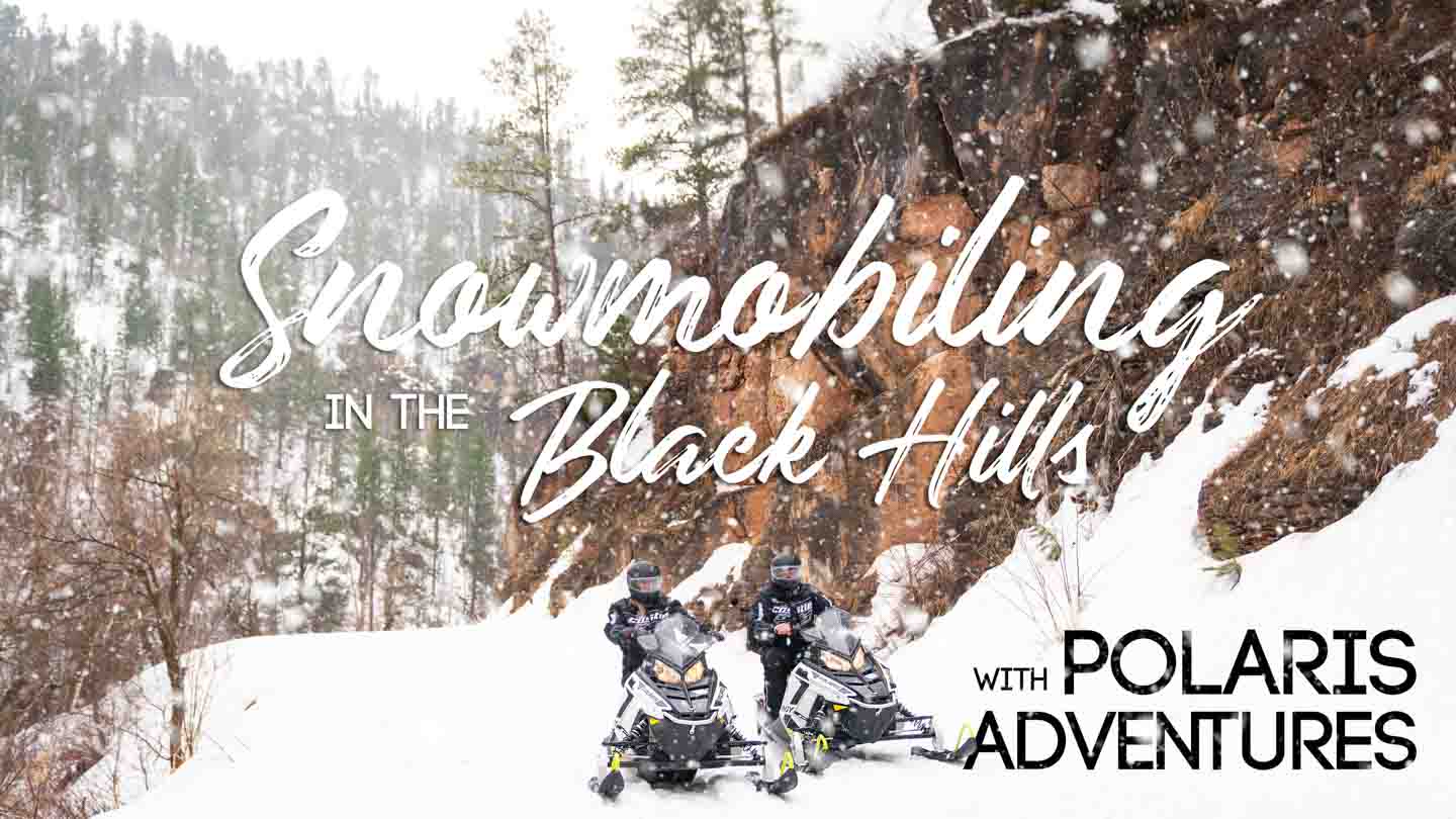 Couple snowmobiling in the Black hills - Polaris Adventures - Featured Image