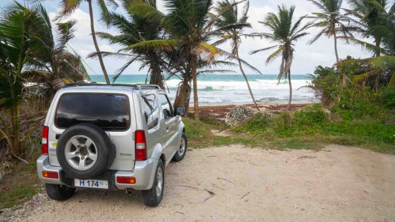 silver colored rental car parked in front of the beach - Things to do in Barbados