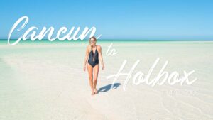 Woman standing on a sand bankl in Isla Holbox - Featured image for Cancun to Holbox