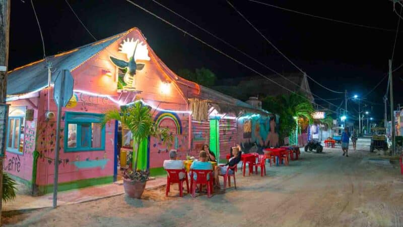 Best Restaurants Isla Holbox - Pink building at night and sand covered streets - Holbox at night