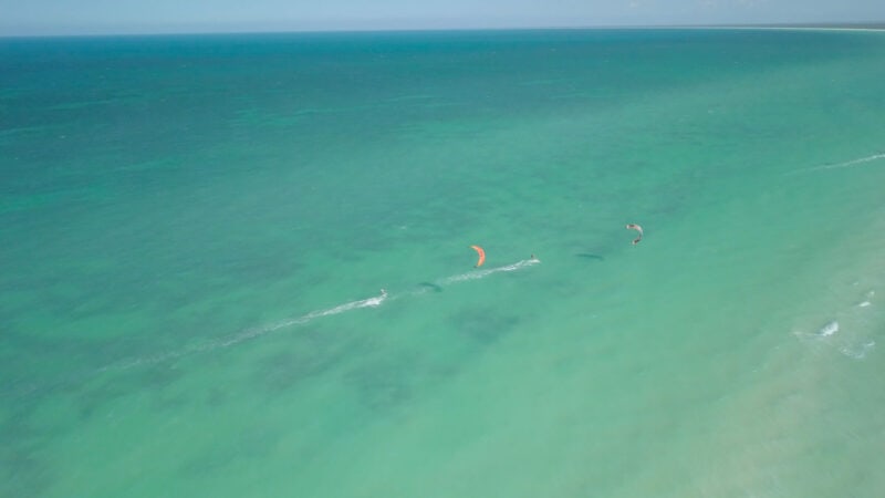 two kite surfers in the water at punta mosquito - kite surfing Isla Holbox - top tourist Things to do