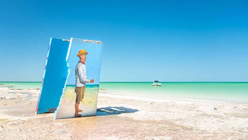 large mural of a man fishing on the beach of Isla Holbox Island Mexico