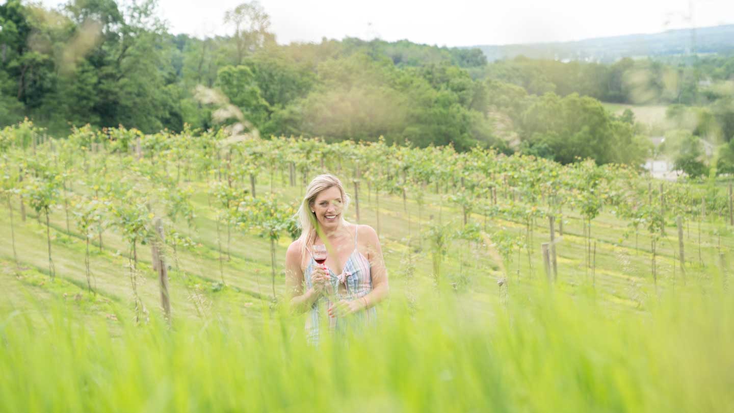 woman stading in a vineyard wine tasting in Wisconsin Dells - Things to do in the Dells - Wisconsin