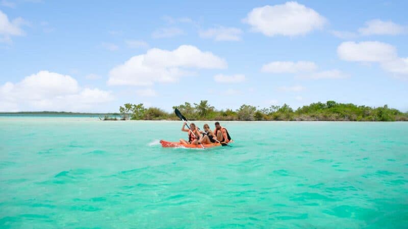 group of people kayaking in Laguna Bacalar Mexico - Things to do in Bacalar