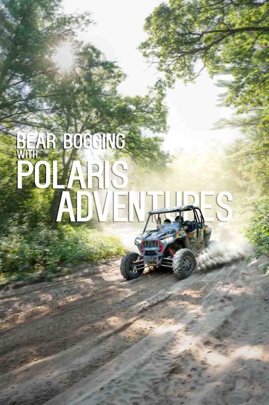 Black RZR coming around a corner in a dusty ATV trail - Renting a UTV or ATV in Wisconsin 