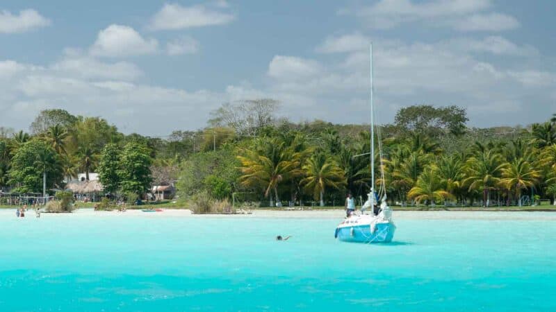 white and blue sailboat in the laguna Bacalar in Mexico