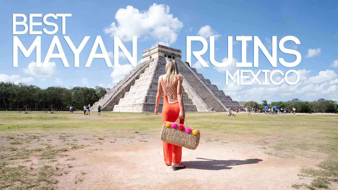 woman in an orange dress standing in front of Chichén Itzá - Best mayan Ruins in Mexico