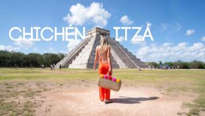 Woman walking infront of El Castillo Pyramid at Chichén Itzá Mayan Ruins Site - Featured Image with White Text