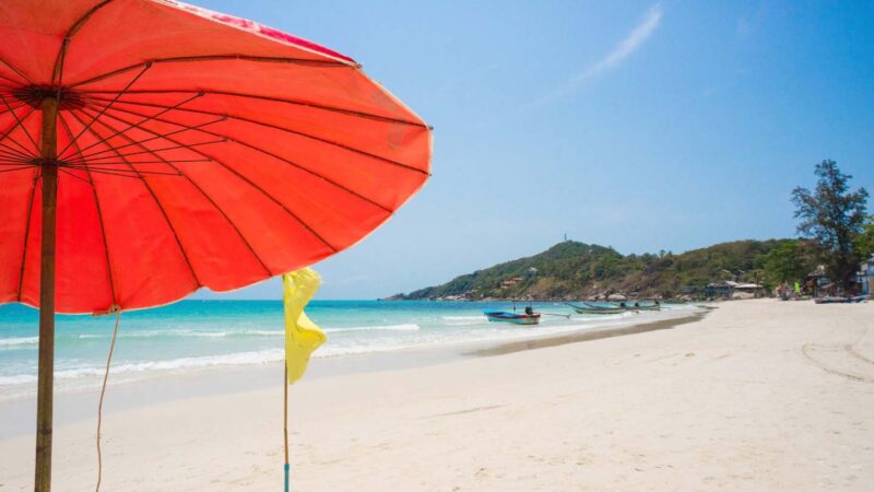 red umbrella on Haad Rin Beach in Koh Phangan home of the famous full moon parties in Thailand