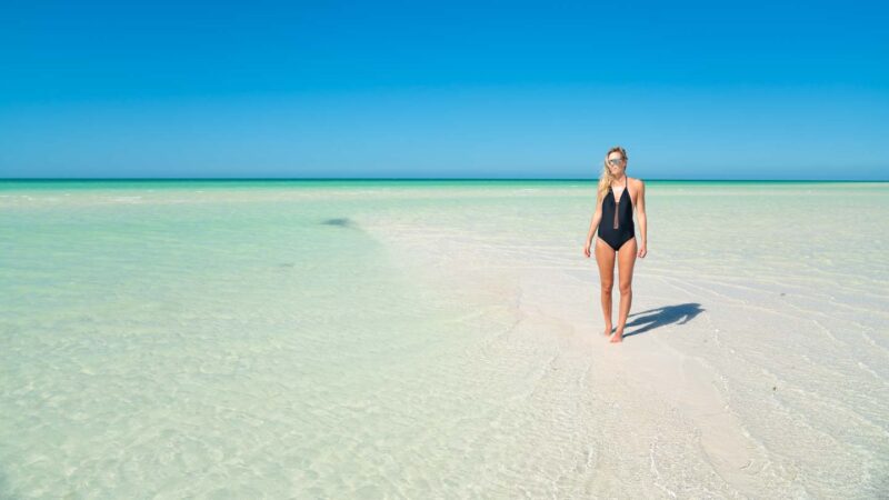 woman standing on a sandbank in Isla Holbox Mexico - Places to visit