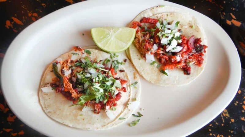 Plate of two tacos from a local taco place in Cancun - Must try things in Cancun Mexico