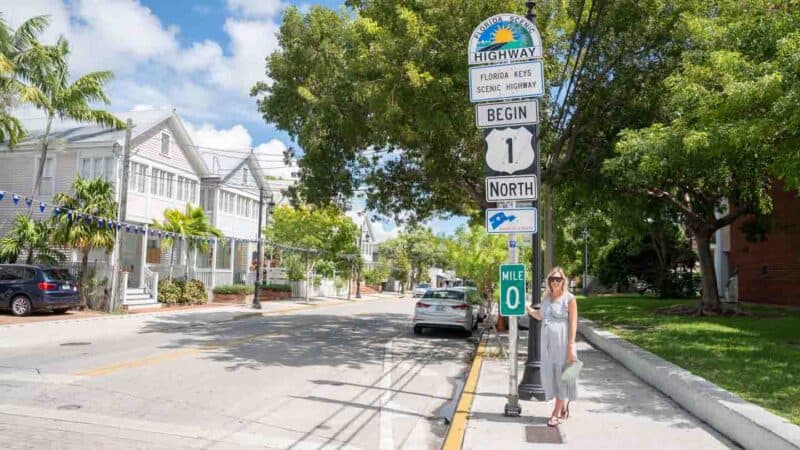 woman standing in front of the mile marker 0 in Key West Florida - Road Trip Itinerary