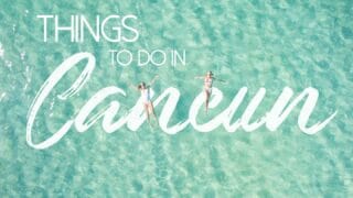 Two women swimming in Cancun clear aqua colored water - Featured image for Things to do in Cancun Mexico