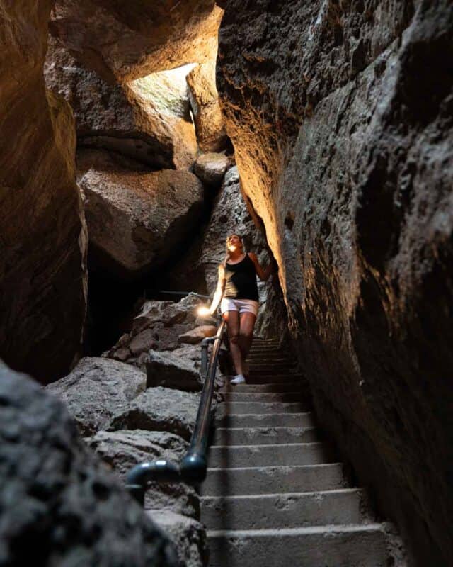 Woman inside of Bear Gultch Cave in Pinnacles National Park - California Road Trips