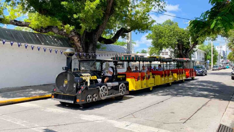 Black Conch tour train driving on the streets of Key West - Top Tourist Attractions