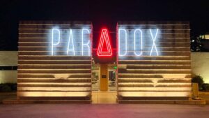 Night time exterior photo of the Paradox Hotel in Santa Cruz - White and Red Neon Lights
