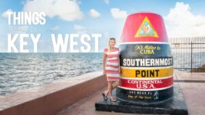Woman standing infront of the famous Southermost Point Marker - Things to do in Key West