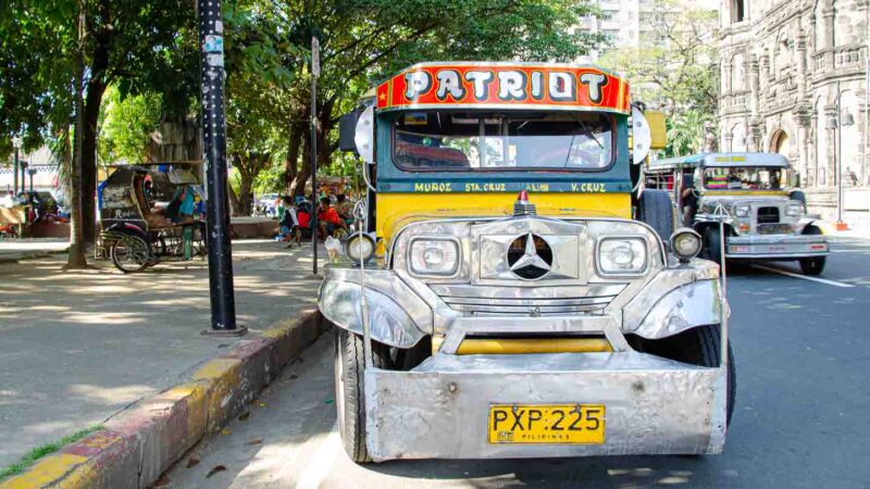 Yellow and green Jeepney with chrome trim parked in Manila - Must see Philippines