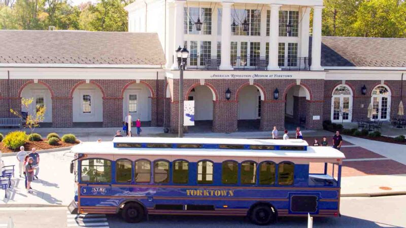 Blue Yorktown trolly in front of the American Revolution Museum at Yorktown - Top things to do in Williamsburg VA