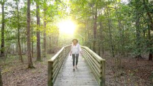Woman walking on the greenspring interpretive trail - Outdoor things to do in Williamsburg