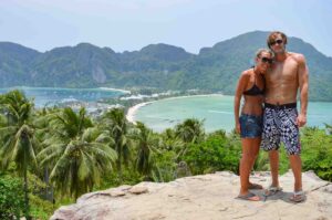 couple standing at the top of the Koh Phi Phi Viewpoint after a hike - Top Things to do