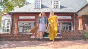 Two women walking through Merchant Square with shopping bags - Top things to do in Williamsburg Virginia