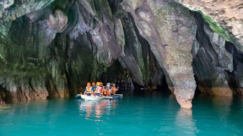 Group of visitors exiting the Puerto Princessa Underground River in a small boat