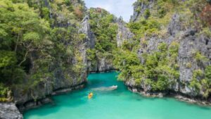 Yellow Kayak entering the small lagoon in El Nido - Top things to do in the Palawan Islands