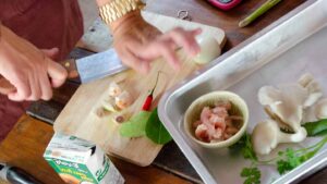 Woman cutting food duing a Thai Cooking class - Top activities in Koh Phangan Thailand