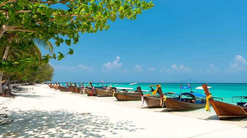 A line of long tail boats parked on the coast of Bamboo Island Thailand - Top attractions near Koh Phi Phi Don