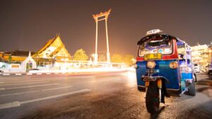 Long exposure photo of a Blue tuk tuk parked in Bangkok