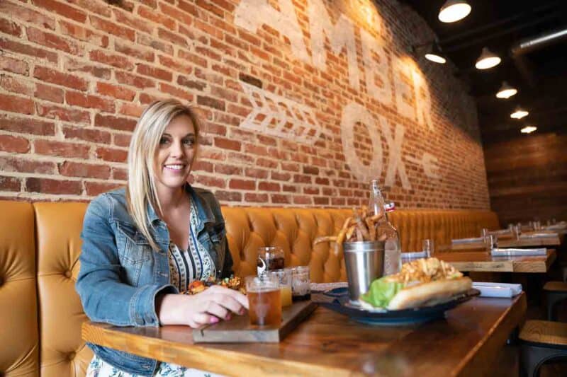 woman eating at Amber Ox a Top rated restaurant in Williamsburg Virginia