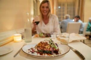 Woman drink wine at Le Yuca dining room - Top rated French restaurant in Williamsburg VA