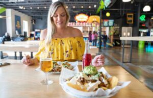 Woman eating at Precarious Beer Project at the electric Circus Taco Bar - Top new restaurants in Williamsburg VA