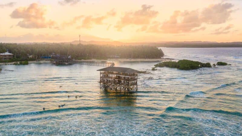 Drone photo of a sunset behind the Cloud 9 Surf Break viewing platform
