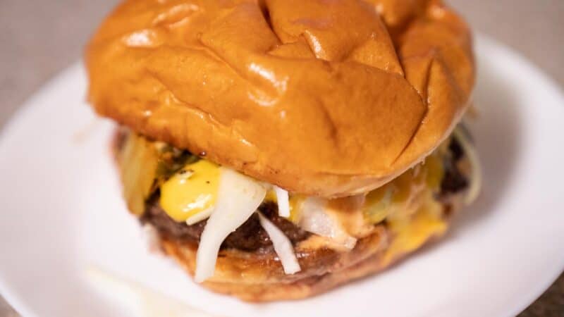 Take out burger with cheese and onions from Crave Cafe a top burger place