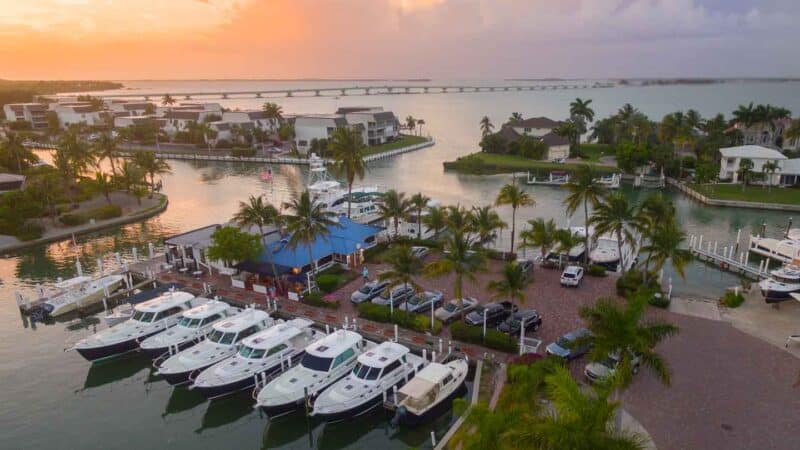 Drone phot of Gramma Dots Seaside Saloon during a pink and orange sunset - Best Restaurant Guide Ft Myers FL