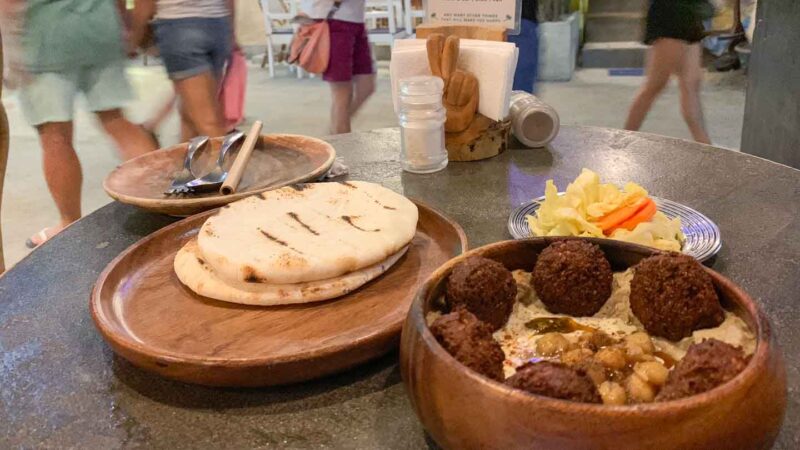 Falafel severed in a bowl of hummus with pitas at Happiness restaurant in El Nido - Top places to eat