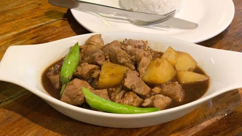 A plate of traditioanl Filipino food served on a white plate at Maa's Grill in El Nido - Top Restaurants