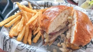 Sobelman's pub and grill burger cut in half with french fries - Milwaukee, Wisconsin