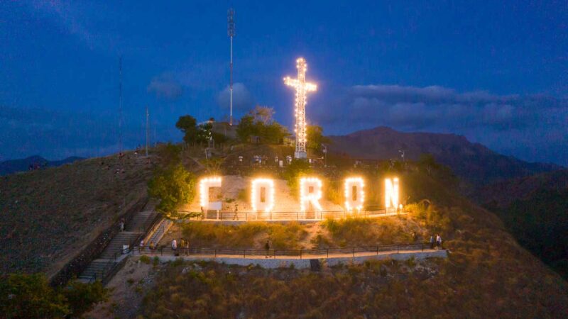 Aerial photo of the top of Mt. Tapys at night with the lights of the Coron sign lit