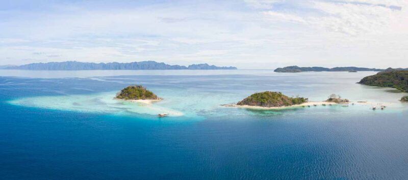 Far drone photo of 2 Seasons resort island Coron with near by sandbank island