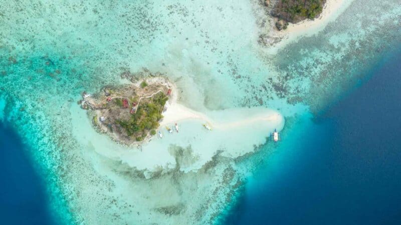 High Level Straight down drone photo of Bulog Dos Island Coron showing multiple shades of blues and two small islands