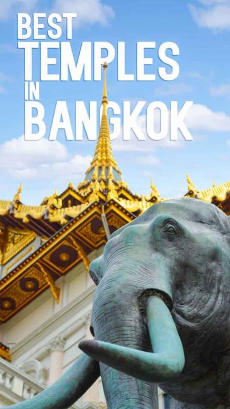 Green elephant statue with a famous Bangkok Temple in the Back ground with golden roof