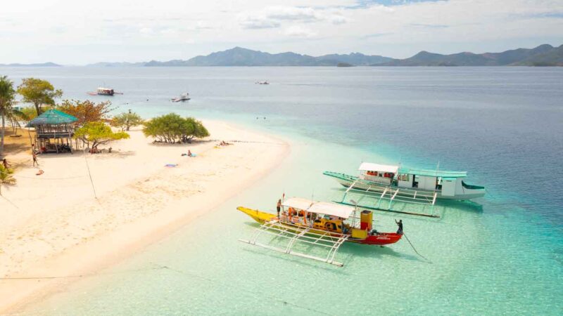Drone photo of two boats anchored infront of Banana Island on a day trip from Coron Philippines