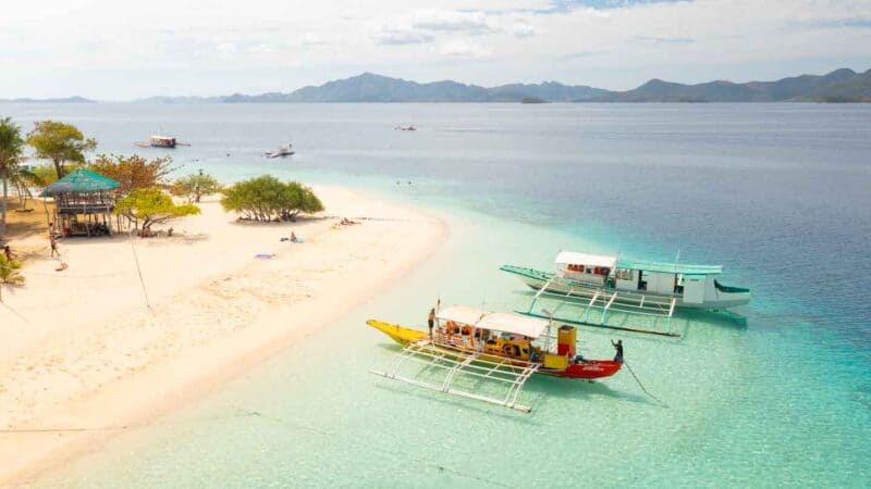 Drone photo of two boats anchored infront of Banana Island on a day trip from Coron Philippines