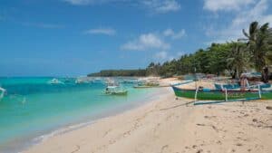 view down the beach of Daku Island with boats beached and in the water