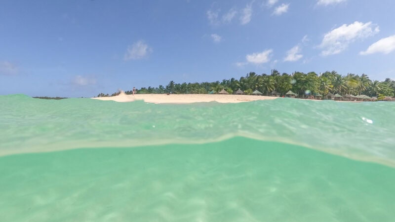 view over and under water infront of Daku Island shot with a gopro dome